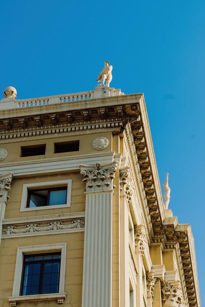 A tall building with statues on top of it